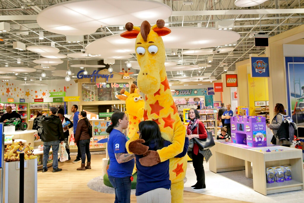 In this Dec. 9, 2019, file photo a girl hugs the Toys R Us mascot, Geoffrey, at the new store at a mall in Paramus, N.J The only two Toys R Us stores that opened in November 2019 as part of a small U.S. comeback attempt by the iconic toy chain have now closed. The Toys R Us store at the Galleria mall in Houston shuttered on Jan. 15, while one at the Garden State Plaza in Paramus, New Jersey, closed on Tuesday, Jan. 26, 2021 according Tru Kids, a new entity formed when it acquired Toys R Us&rsquo; intellectual property during its liquidation in 2018.
