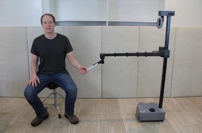 Georgia Tech robotics expert Charlie Kemp poses with his robot Stretch RE1 from Hello Robot, Inc. Robots like Stretch REI will be used in the TRI research to improve how people and robots work together.