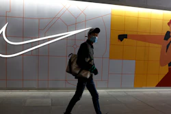A mall visitor passes by a Nike store in Beijing on Monday, March 29, 2021.