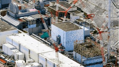 This Sept. 4, 2017, aerial file photo shows Fukushima Dai-ichi nuclear power plant reactors, from bottom at right, Unit 1, Unit 2 and Unit 3, in Okuma town, Fukushima prefecture, northeastern Japan. The head of the wrecked Fukushima nuclear plant said Tuesday, March 2, 2021 there's no need to extend the current target to finish its decommissioning in 30-40 years despite uncertainties about melted fuel inside the plant's three reactors.