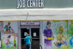 In this file photo, a person looks inside the closed doors of the Pasadena Community Job Center.