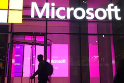 In this Nov. 10, 2016, file photo, people walk past a Microsoft office in New York. China-based government hackers have exploited a bug in Microsoft's email server software to target U.S. organizations, the company said Tuesday, March 2, 2021.