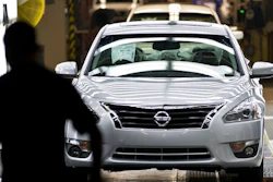 In this May 15, 2012, file photo, a worker walks by a new Nissan Altima on the line after the company celebrated the start of production of the fifth generation of the model at the plant in Smyrna, Tenn. A union wants to hold a vote for representation of fewer than 100 out of thousands of workers at the Nissan vehicle assembly plant in Tennessee, a move the company opposes because the effort doesn't stretch more broadly across the facility's workforce. The National Labor Relations Board began hearing arguments Friday, March 12, 2021, in a case over whether a vote can be held for the subset of employees.