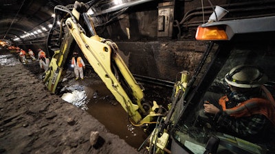 Amtrak workers perform tunnel repairs to a partially flooded train track bed, Saturday, March 20, 2021, in Weehawken, N.J.