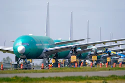 A line of Boeing 777X jets are parked nose to tail on an unused runway at Paine Field, near Boeing's massive production facility, Friday, April 23, 2021, in Everett, Wash. Boeing Co. on Wednesday, April 28, reported a loss of $537 million in its first quarter. The Chicago-based company said it had a loss of 92 cents per share. Losses, adjusted for non-recurring gains, were $1.53 per share.