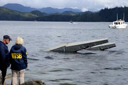 In this photo provided by the National Transportation Safety Board, NTSB investigator Clint Crookshanks, left, and member Jennifer Homendy stand near the site of some the wreckage.