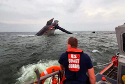 A Coast Guard Response Boat searches for survivors near the capsized SeaCor Power, an oil industry vessel.