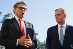 In this Thursday, July 26, 2018 file photo, Secretary of Energy Rick Perry, left, with the main cyrogenic heating exchange behind him, and Thomas Farrell, II, chairman, president and CEO, Dominion Energy, speak with reporters at Dominion Energy's Cove Point LNG liquefaction Project facility in Lusby, Md., Tom Farrell, who led Dominion Energy for more than a decade, has died Friday, April 2, 2021 one day after he stepped down from his post. He was 66.