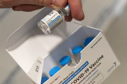 In this file photo, a pharmacist holds a vial of the Johnson & Johnson COVID-19 vaccine.