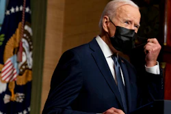 In this Wednesday, April 14, 2021, file photo, President Joe Biden removes his mask to speak at a news conference at the White House, in Washington. Ten liberal senators are urging Biden to back India and South Africa’s appeal to the World Trade Organization to temporarily relax intellectual property rules so coronavirus vaccines can be manufactured by nations that are struggling to inoculate their population.