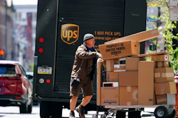 A UPS driver delivers packages in Philadelphia, Monday, April 26, 2021. A surge in the volume of deliveries that arrived with the start of the pandemic has not eased at UPS, where consolidated average daily volume jumped 14.3% in the first quarter. The Atlanta company on Tuesday, April 27 posted earnings of $4.79 billion, or $5.47 per share.