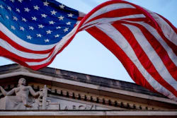 In this March 22, 2019 file photo, an American flag flies outside the Department of Justice in Washington. The Justice Department has assembled a task force to confront ransomware after what officials say was the most costly year on record for the crippling cyberattacks.