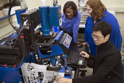 Tahira Reid Smith (left) works with colleagues using an infrared microscope to study how heat affects hair.