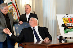 West Virginia Gov. Jim Justice, center, shakes hands with West Virginia Great Barrel Co. managing partners Tom Crabtree, left, and Philip Cornett at an announcement in Charleston, Oct. 19, 2017.