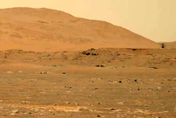 The Mars Ingenuity helicopter flies over the surface of the planet, April 30, 2021.