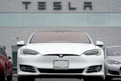 This Sunday, May 9, 2021 file photo shows vehicles at a Tesla location in Littleton, Colo. According to the U.S. National Transportation Safety Board, home security camera footage shows that the owner of a Tesla got into the driver's seat of the car shortly before a deadly crash in suburban Houston. But the preliminary report on the crash that killed two men doesn't explain why police found no one behind the wheel of the car, which burst into flames after crashing about 550 feet (170 meters) from the owner's home.