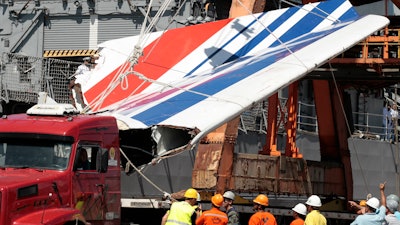 Workers unload debris from Air France flight AF447, Recife, Brazil, June 14, 2009.