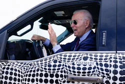 President Joe Biden stops to talk to the media as he drives a Ford F-150 Lightning truck, Ford Dearborn Development Center, Dearborn, Mich., May 18, 2021.