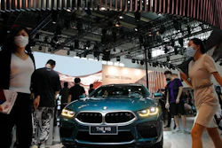 In this Sept. 27, 2020 file photo, visitors gather near a BMW M8 model on display at the Auto China 2020 show in Beijing, China. Booming sales in China helped propel German luxury carmaker BMW to stronger profits in the first three months of the year even as its home market Germany trailed the ongoing recovery in global car markets from the worst of the pandemic shutdowns.