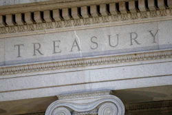 This file photo shows the U.S. Treasury Department building at dusk in Washington.
