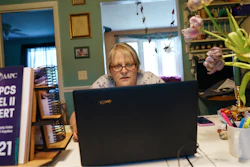 Ellen Booth, 57, studies at her kitchen table to become a certified medical coder in Coventry, RI.