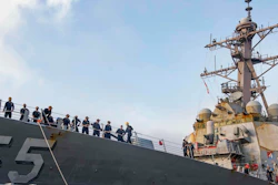 In this photo provided by the U.S. Navy, sailors aboard the guided missile destroyer USS Stout handle mooring lines during the ship's return to home port at Naval Station Norfolk, in Norfolk, Va., in this Oct. 12, 2020, photo. The USS Stout showed rust as it returned from the 210-day deployment. The rust was quickly removed and the ship repainted. But the rusty ship and its weary crew underscored the costly toll of deferred maintenance on ships and long deployments on sailors.
