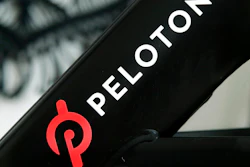 This Nov. 19, 2019 file photo shows a Peloton logo on the company's stationary bicycle in San Francisco. Peloton is recalling its treadmills after one child died and 29 other children suffered from cuts, broken bones and other injuries from being pulled under the rear of the treadmill. The U.S. Consumer Product Safety Commission said Wednesday, May 5, 2021, that Peloton received 72 reports of adults, kids, pets or other items, such as exercise balls, being pulled under the treadmill.