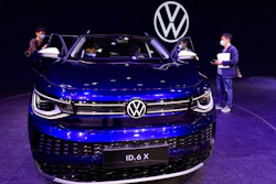 In this April 20, 2021 file photo, visitors look at the latest electric car from Volkswagen during the Shanghai Auto Show in Shanghai, China. Volkswagen's earnings bounced back strongly in the first quarter. The company is riding the strong recovery from the pandemic in China, its single biggest market these days.