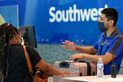 In this file photo a Southwest Airlines employee assists a passenger at the ticket counter.