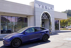 In this April 2, 2021 file photo two women in an electric car drive into a Tesla delivery location and service center in Corte Madera, Calif. California’s Department of Motor Vehicles is reviewing whether Tesla is violating a state regulation by advertising its vehicles as being fully autonomous without meeting the legal definition of self-driving The department says Monday, May 17, 2021 that the regulation prohibits advertising vehicles for sale or lease as autonomous if the regulation isn’t met.