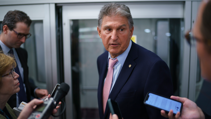 Sen. Joe Manchin, D-W.Va., a key infrastructure negotiator, pauses for reporters after working behind closed doors with other Democrats in a basement room at the Capitol in Washington, Wednesday, June 16, 2021.