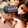 Gloria Gantes, right, monitors Terry Colli, a resident of John Knox Village, as he participates in a virtual reality study, June 1, 2021, Pompano Beach, Fla.