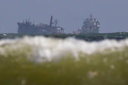 The MV X-Press Pearl, left, is pulled by a navel vessel at Kapungoda, where it is anchored off Colombo port, Sri Lanka, June 2, 2021.