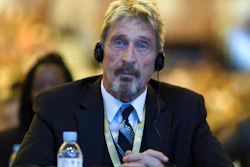 John McAfee listens during the 4th China Internet Security Conference in Beijing, Aug. 16, 2016.