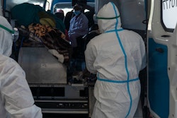 Health workers arrive with a patient at the Chris Hani Baragwanath Academic Hospital's COVID-19 facility, Johannesburg, June 21, 2021.
