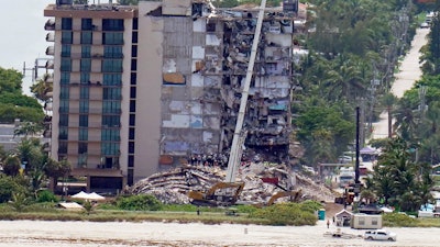 Workers search in the rubble at the Champlain Towers South Condo, Saturday, June 26, 2021, in Surfside, Fla. One hundred fifty-nine people were still unaccounted for two days after Thursday's collapse, which killed at least four.