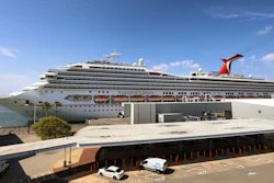 In this Wednesday, May 12, 2021, file photo, the Carnival Cruise ship 'Liberty' is docked at Port Canaveral, Fla. Carnival Corp. continues to lose billions while it waits for cruising to recover from the pandemic.