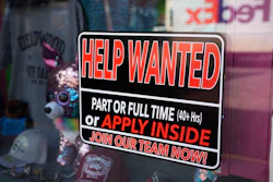 In this May 26, 2021 photo, a sign for workers hangs in the window of a shop along Main Street in Deadwood, S.D. U.S. employers added 559,000 jobs in May, an improvement from April’s sluggish gain but still evidence that many companies are struggling to find enough workers as the economy rapidly recovers from the pandemic recession.