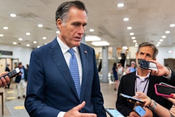 Sen. Mitt Romney, R-Utah, speaks to reporters as he walks on the Senate subway on Capitol Hill, Tuesday, June 8, 2021, in Washington.