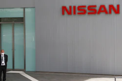 A man stands at Nissan Motor Co.'s global headquarters in Yokohama, near Tokyo, Tuesday, June 22, 2021. Nissan Chief Executive Makoto Uchida pleaded for patience from disgruntled shareholders Tuesday, promising a turnaround at the Japanese automaker, which is projecting a third year of losses as it struggles to distance itself from a scandal over its former Chairman Carlos Ghosn.