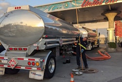 In this photo, a fuel truck driver checks the gasoline tank level at a United Oil gas station on Sunset Blvd., in Los Angeles.