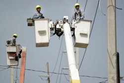 In this Oct. 19, 2017 file photo, Puerto Rico Electric Power Authority workers repair distribution lines damaged by Hurricane Maria in the Cantera community of San Juan, Puerto Rico. Luma, the private company that took over power transmission and distribution in June 2021 has struggled with widespread outages, affecting more than 1 million customers so far in its first two weeks.