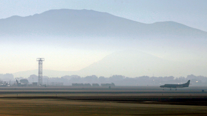 In this Sept. 24, 2014 file photo, smoke hangs over Reno-Tahoe International Airport as a plane takes off in Reno, Nev. A shortage of jet fuel, coupled with supply chain issues and an urgent demand from firefighting aircraft, continues to cause problems at airports around the West.