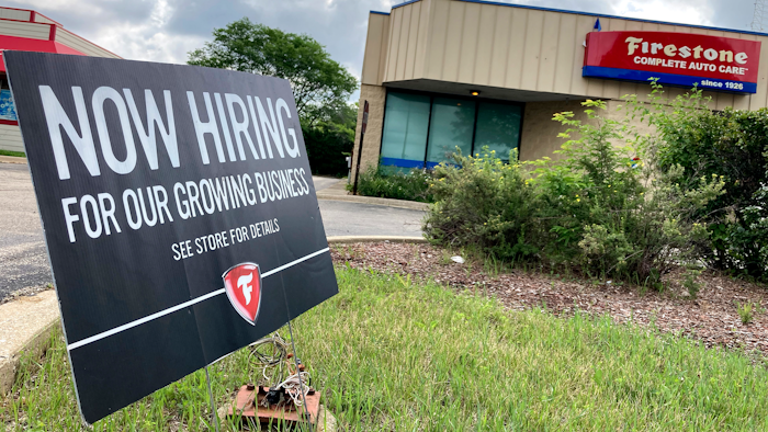 A hiring sign is displayed at Firestone Complete Auto Care store in Arlington Heights, Ill., Wednesday, June 30, 2021.