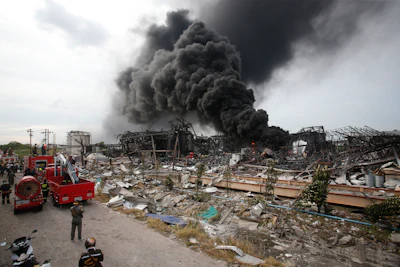Smoke rises into the air from a factory in Samut Prakan province, Thailand, Monday, July 5, 2021. A massive explosion at the factory on the outskirts of Bangkok early Monday shook an airport terminal serving Thailand's capital and prompted the evacuation of residents from the area.