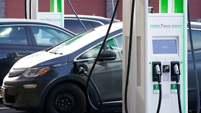 A Chevrolet Bolt charges at an Electrify America site, Lakewood, Colo., Dec. 21, 2020.