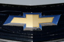 The Chevrolet logo is displayed at a Chevrolet dealership Sunday, Nov. 8, 2020, in Englewood, Colo. General Motors is telling owners of some older Chevrolet Bolts to park them outdoors and not to charge them overnight because two of the electric cars caught fire after recall repairs were made.