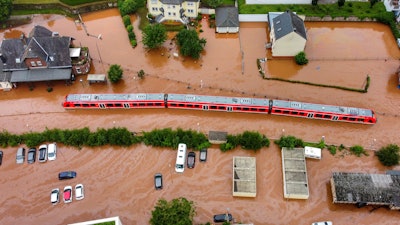 A regional train sits in the flood waters at the local station in Kordel, Germany, Thursday July 15, 2021 after it was flooded by the high waters of the Kyll river.