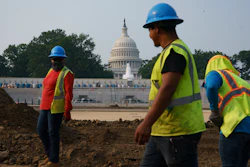 Workers repair a park near the Capitol in Washington, Wednesday, July 21, 2021. About 8 in 10 Americans favor plans to increase funding for roads, bridges and ports and for pipes that supply drinking water.