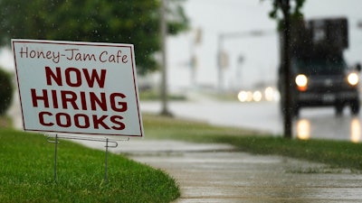 A hiring sign is shown in Downers Grove, Ill., Thursday, June 24, 2021. The number of Americans collecting unemployment benefits slid last week, another sign that the job market continues to recover rapidly from the coronavirus recession.